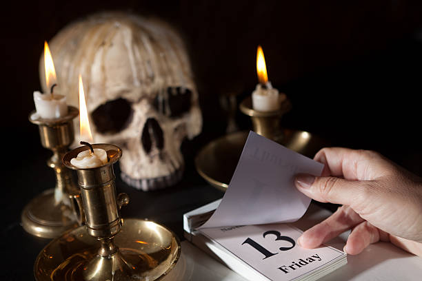 Friday 13th on a calendar Friday 13th on a calendar with candles and a creepy skull friday the 13th stock pictures, royalty-free photos & images