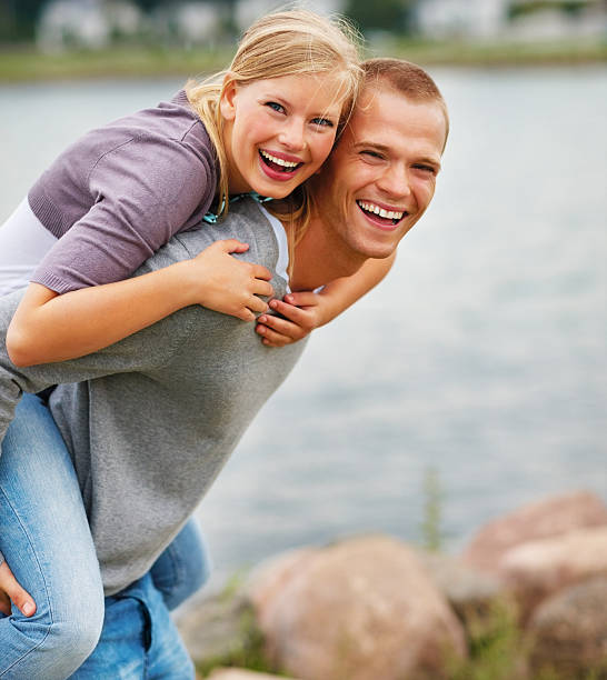 istock Excited young guy piggybacking his girlfriend at beach 151564766