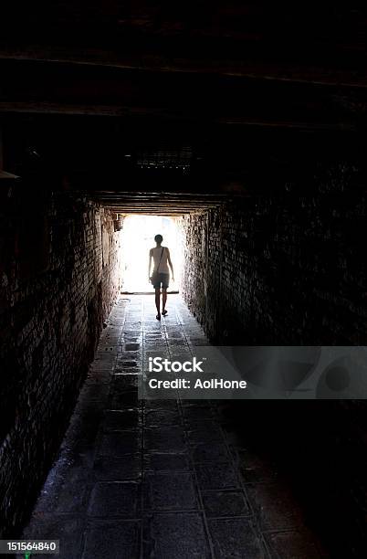 Walking Into The Light From Tunnel Stock Photo - Download Image Now - Adult, Bag, Black Color