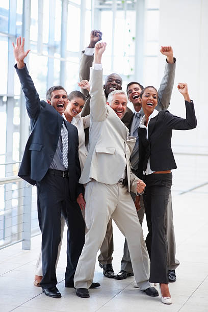 istock Happy successful business colleagues raising hands 151564862