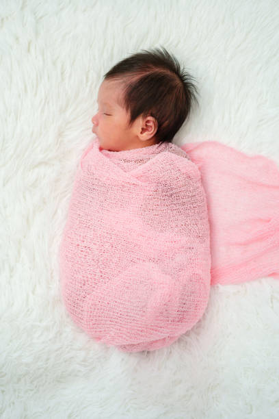 istock newborn baby sleep in cloth wrap blanket on bed 1515648914