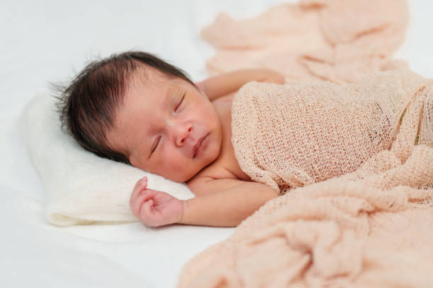 istock newborn baby sleeping in blanket on bed 1515649429