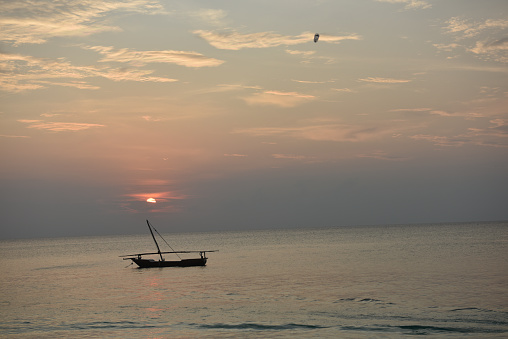 Sunset and traditional wooden fishing boat, Nungwi beach, Zanzibar