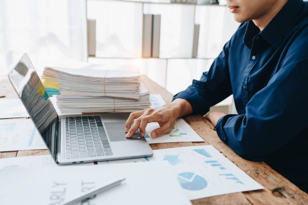istock Businessman using computer laptop with planning working on financial document, tax, exchange, accounting and Financial advisor. 1515689423