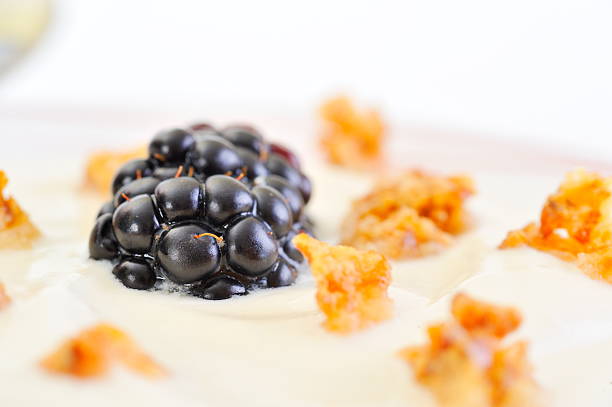 Three white chocolate mousses with a berry topping served in ramekins