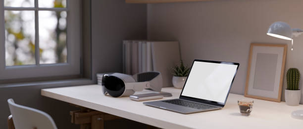 istock Close-up image of a laptop mockup, modern VR goggles on a table. Modern home workspace. 1515689940