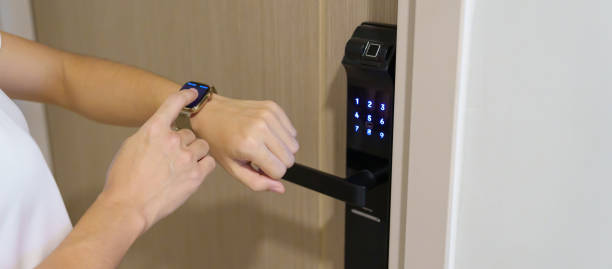 istock Hand using smartwatch for open digital door lock at home or apartment. NFC Technology, Fingerprint scan, keycard, PIN number, smartphone, electrical and contactless lifestyle concepts 1515714024