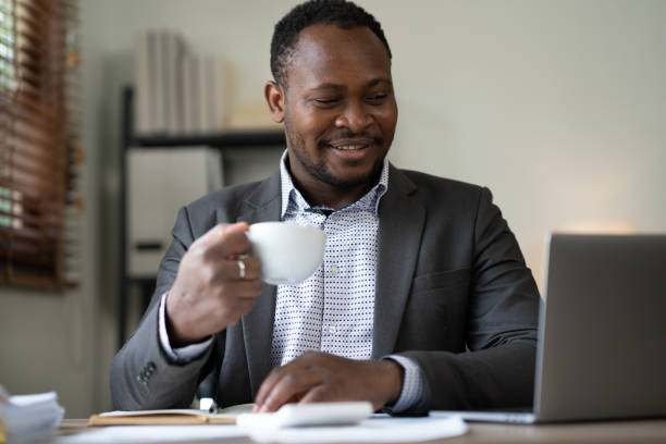 istock Casual businessman resting for coffee break while video conference at office desk 1515716126