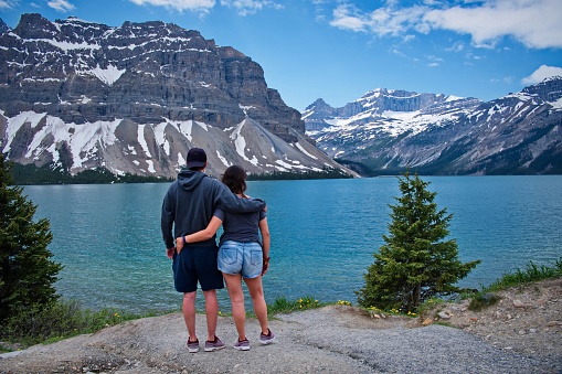 Mature couple standing on the mountain lake shore in Canada BC