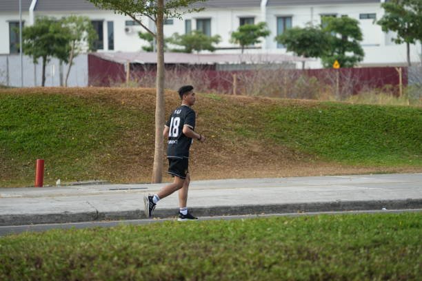 Makassar, Indonesia - June 25 2023: A number of people are jogging in the afternoon in the Center Point Of Indonesia area