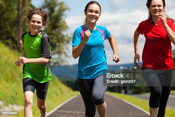 Mother With Kids Running Outdoor Stock Photo - Download Image Now - 14-15 Years, 16-17 Years, 40-44 Years