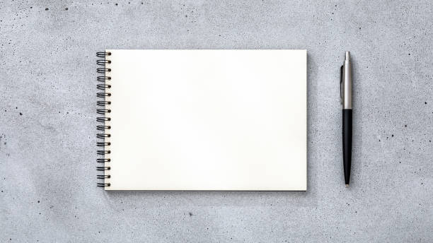 istock Blank notebook page with classic pen on concrete desk 1515766562