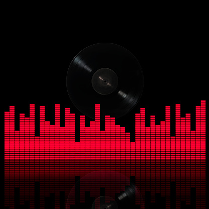 Close-up of LP vinyl record with sound graphic equalizer against black background.