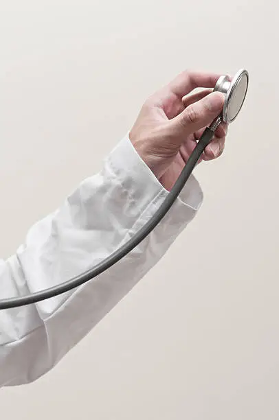 Hand holding stethoscope on clear background