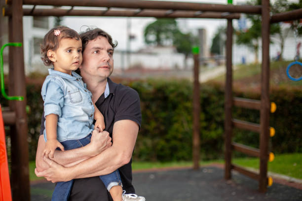 istock Father and daughter staring at horizon on a playground 1515809139