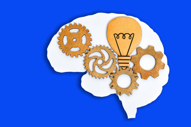 istock Wooden Cogs and Lightbulb in a Flat Human Brain Shape 1515839319