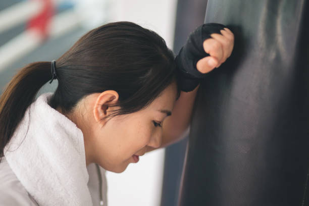 istock Asian woman kickboxing in a training gym 1515865140