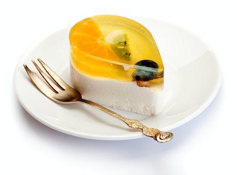 Fruits and jelly cake on white plate