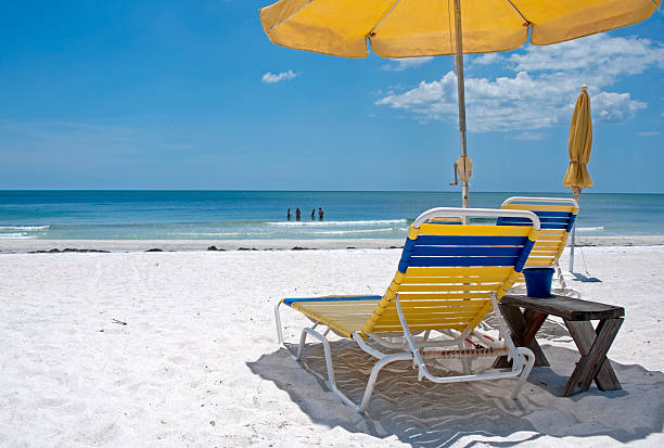 istock Beach chairs and umbrellas 151590070