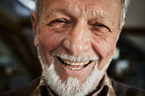 Headshot of happy mature man looking at camera.
