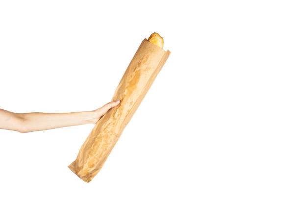 istock French bread baguette in hand isolated on white background. 1515943107