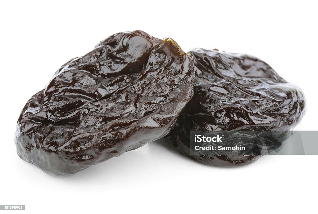 Dried plum fruits - prunes on white Dried plum fruits - prunes isolated on white background Black Color Stock Photo