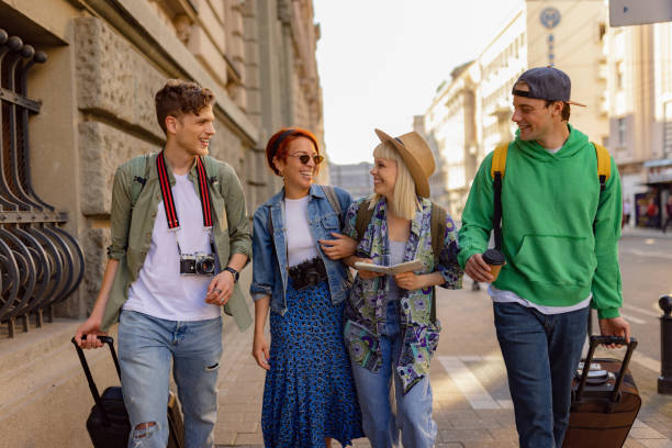 istock Young happy friends talking while walking on the street. 1515979628