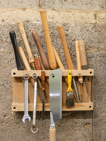 Gouges and various woodturning tools, stored on a homemade wall rack