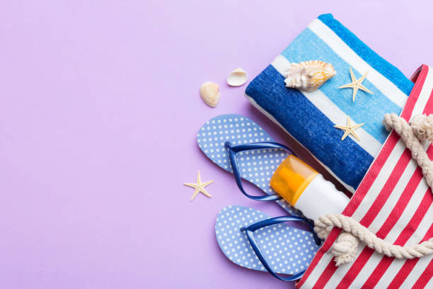 istock beach accessories flat lay top view on colored background Summer travel concept. Bag with starfish and sea shell. Top view 1516014449