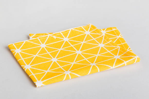 istock top view with yellow empty kitchen napkin isolated on table background. Folded cloth for mockup with copy space, Flat lay. Minimal style 1516015033