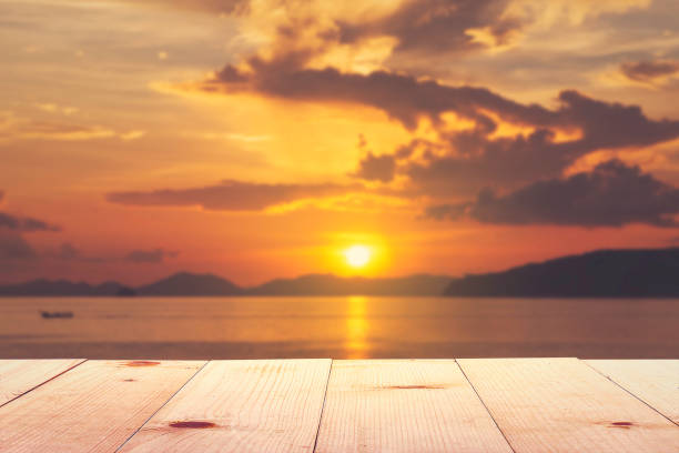 istock wooden table and sea sunset 1516047596