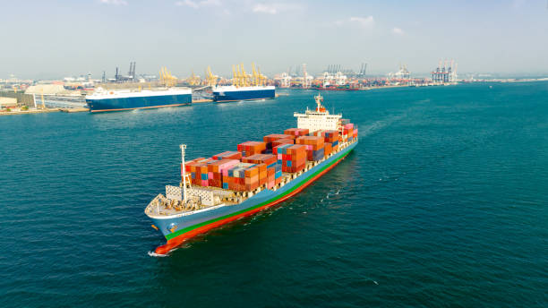 istock cargo container ship carrying in sea to import export goods and distributing products to dealer and consumers across asia pacific worldwide, global business and industry delivery service  by container ship Transport. 1516079373