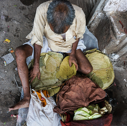 Delhi, India - Jul 26, 2015. Homeless man with all his things on the street in Delhi, India.