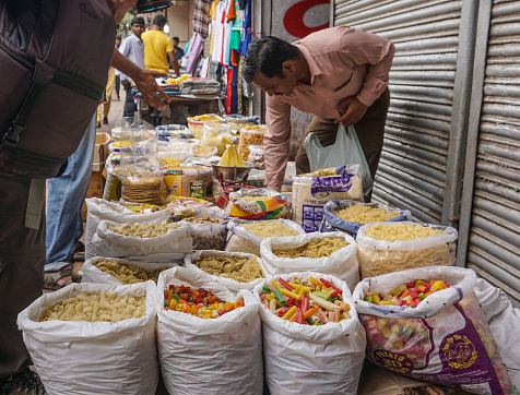 Delhi, India - Jul 26, 2015. Selling foods at street market in Delhi, India. Delhi city proper population was over 11 million, the second-highest in India.