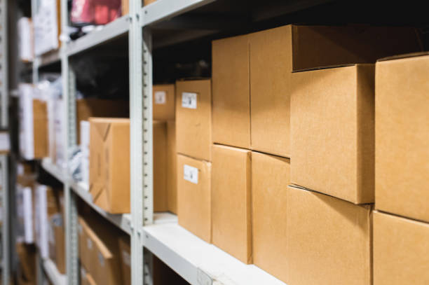istock Cardboard boxes lie on racks in a small warehouse. Logistics transportation and delivery of goods 1516100976