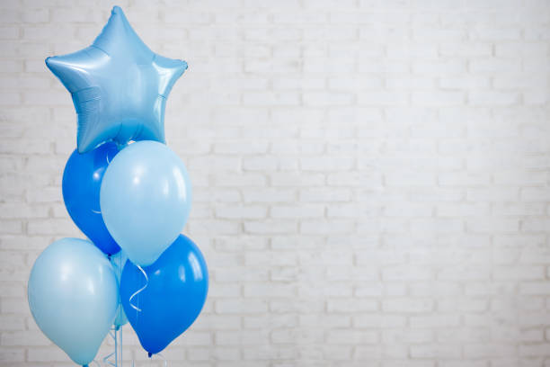 istock blue air balloons over white brick wall background 1516102021