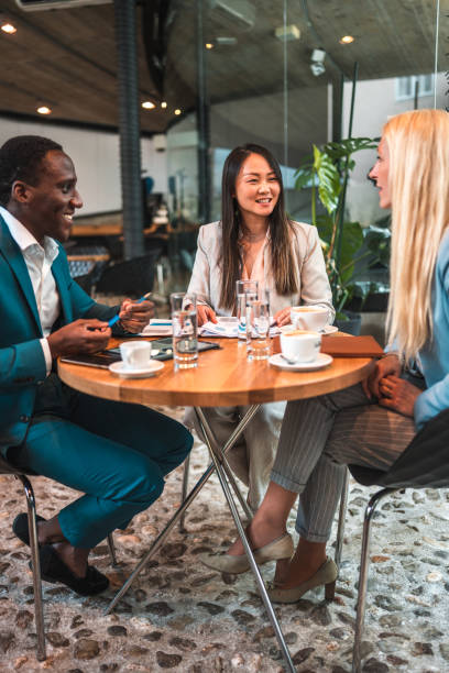 istock Diverse Professionals Brainstorming in a Stylish Cafeteria 1516107512