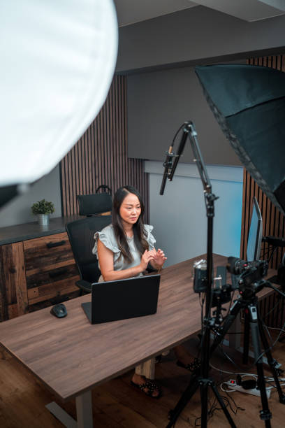 istock Behind the Camera View On Focused Asian Female Content Creator 1516113036