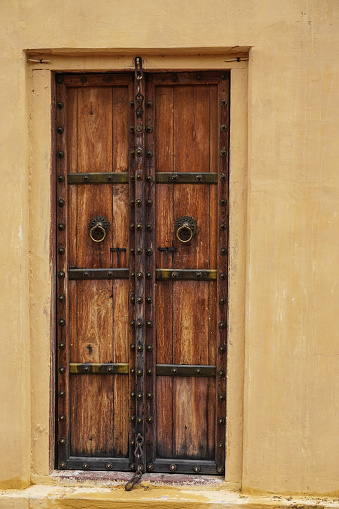 Wooden door of ancient building in Jaipur, India.