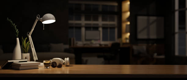 istock A copy space on a wooden tabletop in a modern dark office room at night. 1516121894