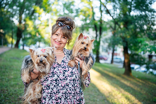 Portrait of smiling woman with her pet dogs.
