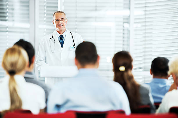 istock Mature doctor giving a speech on  seminar. 151613306