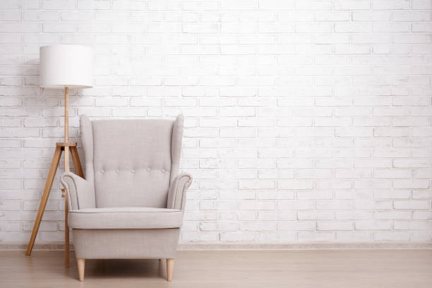 istock Modern armchair and lamp with copy space over brick wall 1516133930