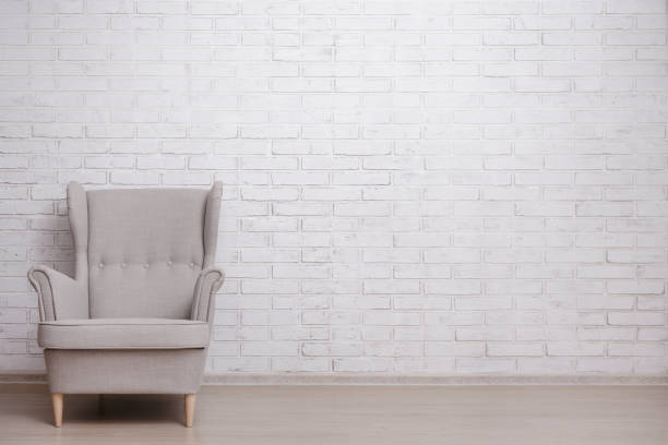 istock Modern armchair with copy space over white brick wall 1516134455
