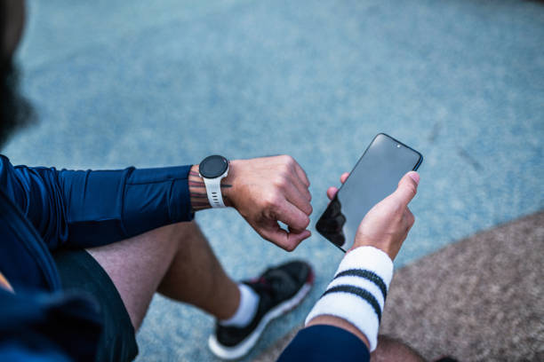istock Using smart watch at a fitness tracker and phone to check workout data 1516145802