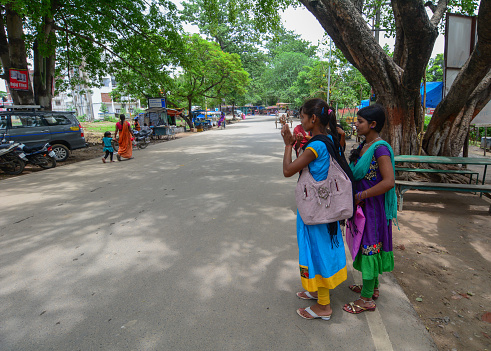 Bodhgaya, India - July 9, 2015. Local people in colorful dress on street in Bodhgaya, India. Bodhgaya is the most revered of all Buddhist sacred sites.
