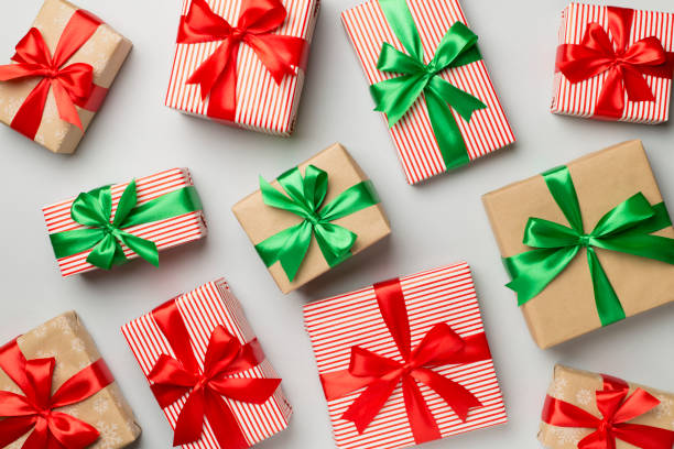 istock Christmas gift boxes on color background, top view 1516157212