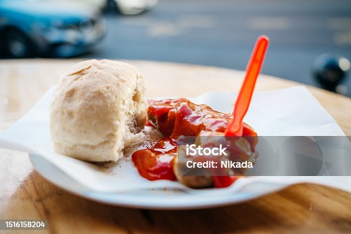 istock Berlin Currywurst, german dish of sliced sausage with a fresh bun 1516158204