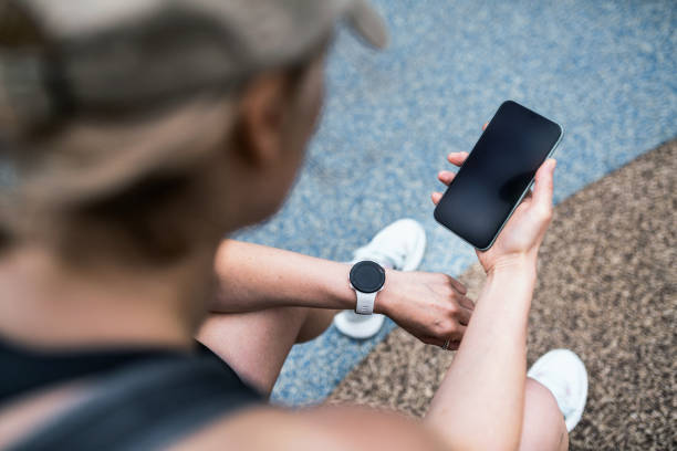 istock Using smart watch at a fitness tracker and phone to check workout data 1516163438