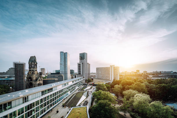 Sunset skyline: Modern Berlin Charlottenburg and Gedächtnis Kirche create a captivating view.